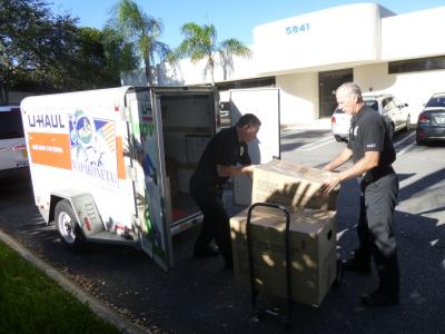 Officers loading boxes into UHaul